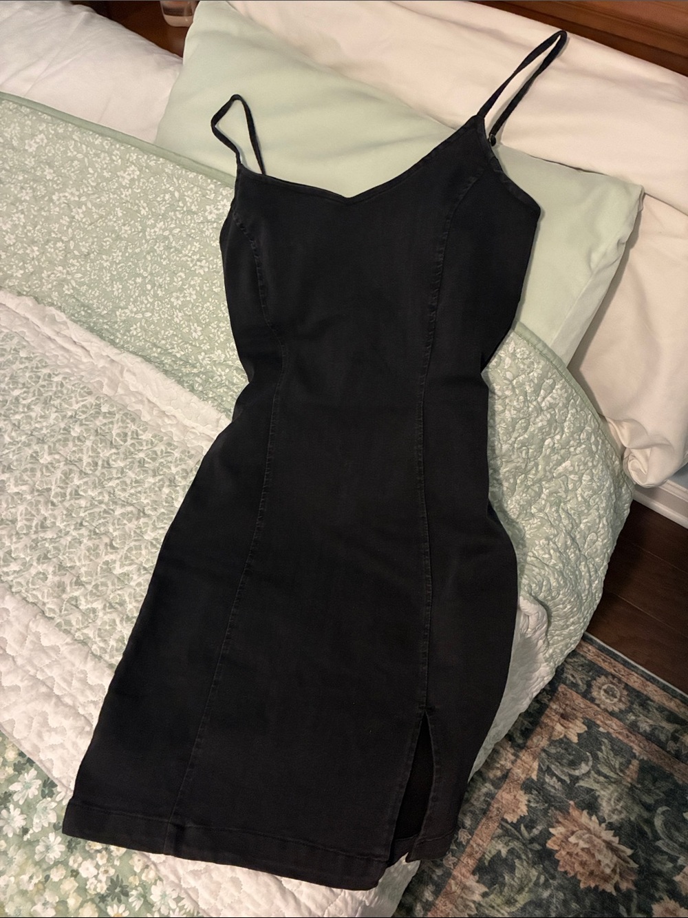 Stretchy black faded denim mini spaghetti strap dress with leg slit.